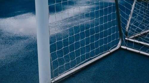 Minimalist Blue Soccer Goal Net on Court Field Desktop Wallpaper