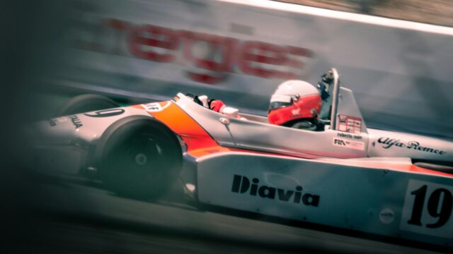 Classic Formula Racing Car Speeding on Track Desktop Wallpaper