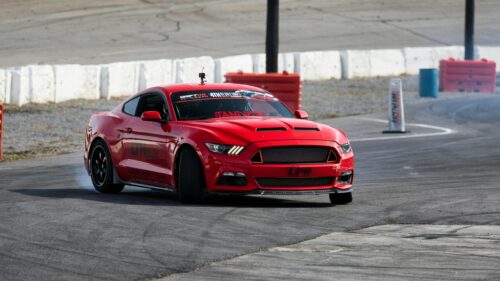 Red Ford Mustang Drifting on Racetrack Desktop Wallpaper