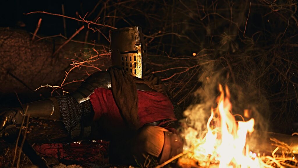 Lone Medieval Knight Resting by Campfire 4K Wallpaper
