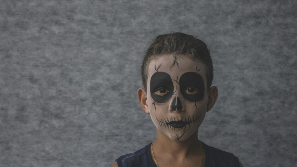 Young Boy with Spooky Skull Face Paint for Halloween Desktop Wallpaper