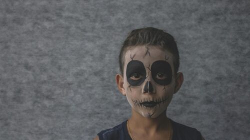 Young Boy with Spooky Skull Face Paint for Halloween Desktop Wallpaper