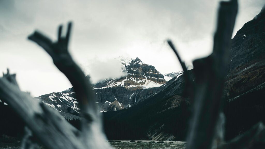 Dramatic Snowy Mountain Peak with Waterfall Frame Desktop Wallpaper