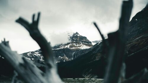 Dramatic Snowy Mountain Peak with Waterfall Frame Desktop Wallpaper