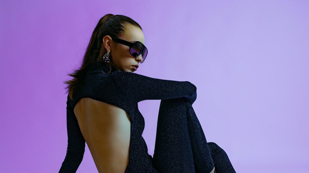 Chic Woman in Sparkly Black Outfit and Designer Sunglasses 4K Desktop Wallpaper