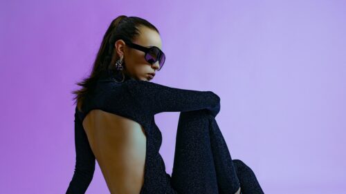 Chic Woman in Sparkly Black Outfit and Designer Sunglasses 4K Desktop Wallpaper