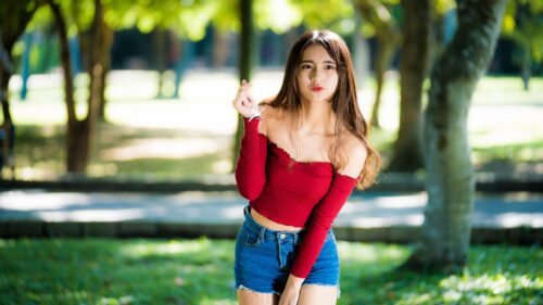 Beautiful Asian Girl Making Finger Heart Gesture in Park Desktop Wallpaper