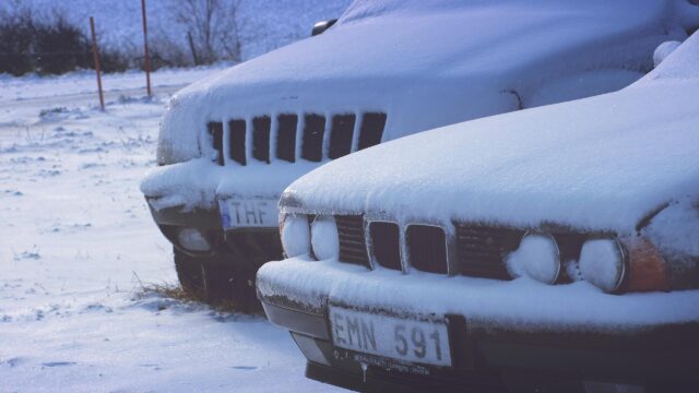 Frozen Luxury Cars Parked in Deep Winter Snow Desktop Wallpaper
