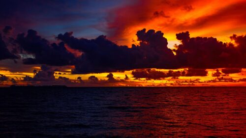 Fiery Sunset Over Tropical Ocean Horizon 4K Wallpaper