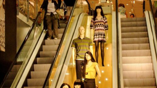 Modern Mall Escalator with Fashion Mannequins 4K Wallpaper