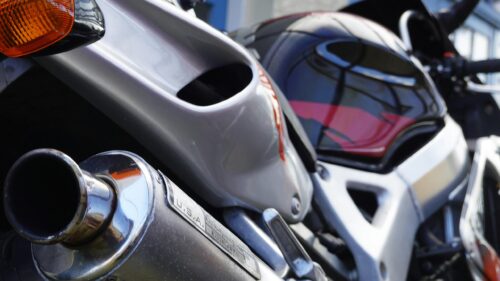 Close-up Silver Sport Motorcycle Exhaust and Sleek Bodywork 4K Wallpaper