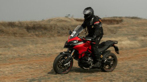 Red Ducati Multistrada Adventure Motorcycle Riding on Dirt Path 4K Wallpaper