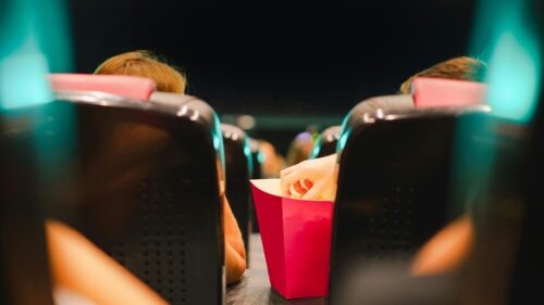 People Enjoying Popcorn at the Cinema Movie Theater 4K Wallpaper