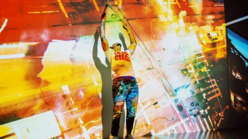Artistic Performance Artist Under City Light Projection 4K Desktop Wallpaper