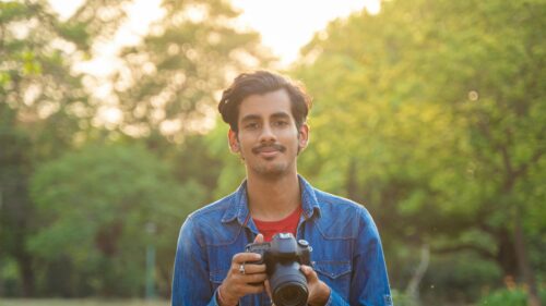 Portrait of a Young Photographer with Camera in Nature 4K Wallpaper