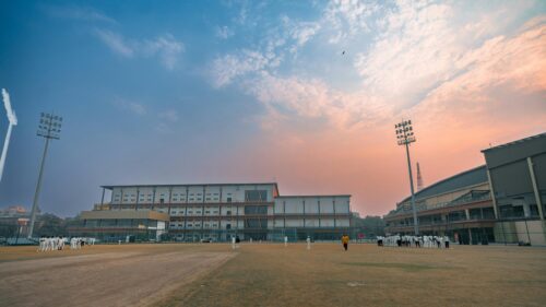 Cricket Players on Field at Sunset Stadium 4K Desktop Wallpaper