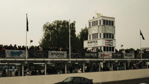 Motorsport Racing Spectators at Circuit Clock Tower 4K Wallpaper