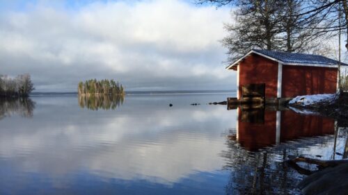 Serene Lake Landscape with Red Cabin and Forest Island PC Wallpaper