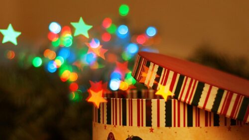 Festive Christmas Gift Box with Colorful Bokeh Star Lights 4K Wallpaper