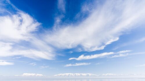 Stunning Snowy Mountain Range Under Clear Blue Sky 4K Wallpaper