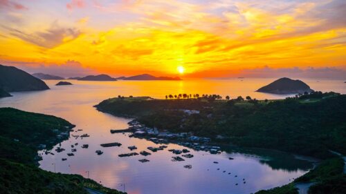 Stunning Golden Sunset Over Coastal Fishing Village Desktop Wallpaper