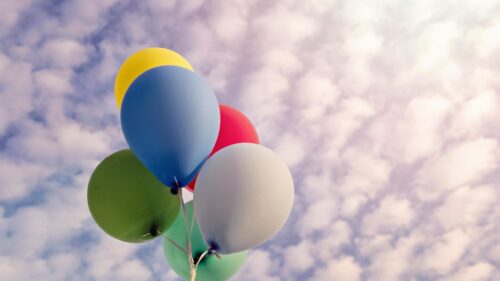 Vibrant Colorful Balloons Floating in Cloudy Sky 4K Desktop Wallpaper