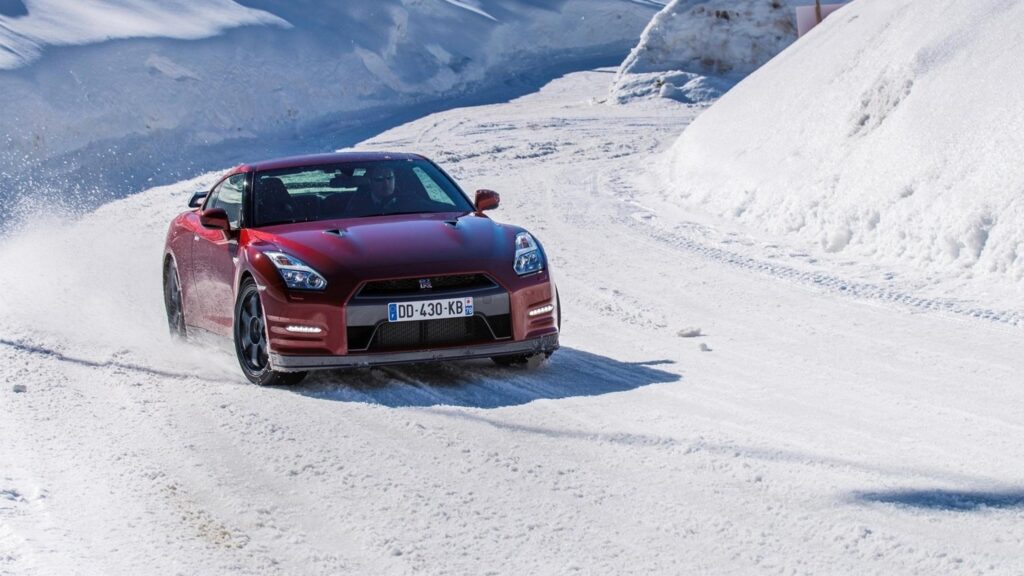 Red Nissan GT R Driving Through Snowy Mountain Road PC Wallpaper