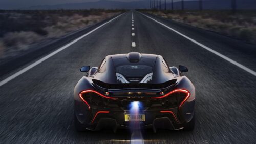 McLaren P1 Supercar Speeding on Open Road at Dusk 4K Wallpaper