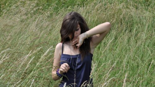 Young Woman Standing in a Tall Grass Meadow Desktop Wallpaper
