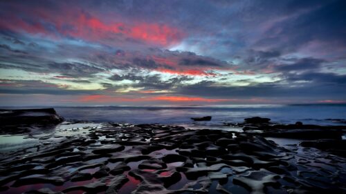 Dramatic Sunset Over Rocky Coastal Shoreline 4K PC Wallpaper