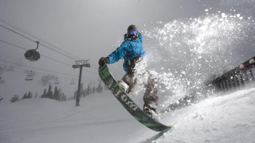 Action Snowboarder Carving Through Fresh Powder 4K PC Wallpaper