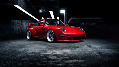 Stunning Red Porsche 911 Sportscar in a Modern Dark Concrete Garage 4K Wallpaper