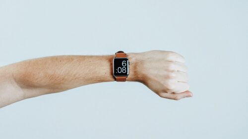 Minimalist Apple Watch with Brown Leather Strap on Wrist PC Wallpaper