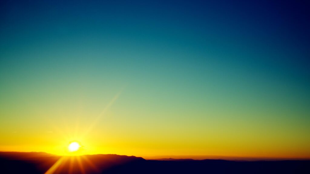 Minimalist Golden Sunrise Over Mountain Silhouettes 4K Desktop Wallpaper