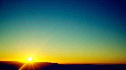 Minimalist Golden Sunrise Over Mountain Silhouettes 4K Desktop Wallpaper