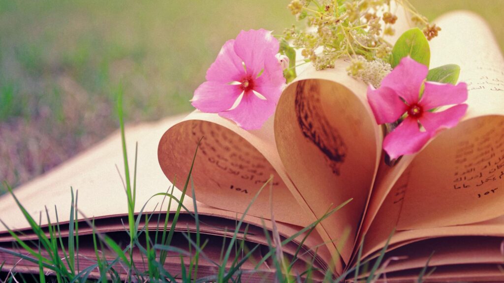Vintage Book Pages Folded into a Heart Shape with Pink Flowers Desktop Wallpaper