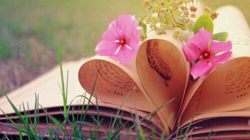 Vintage Book Pages Folded into a Heart Shape with Pink Flowers Desktop Wallpaper