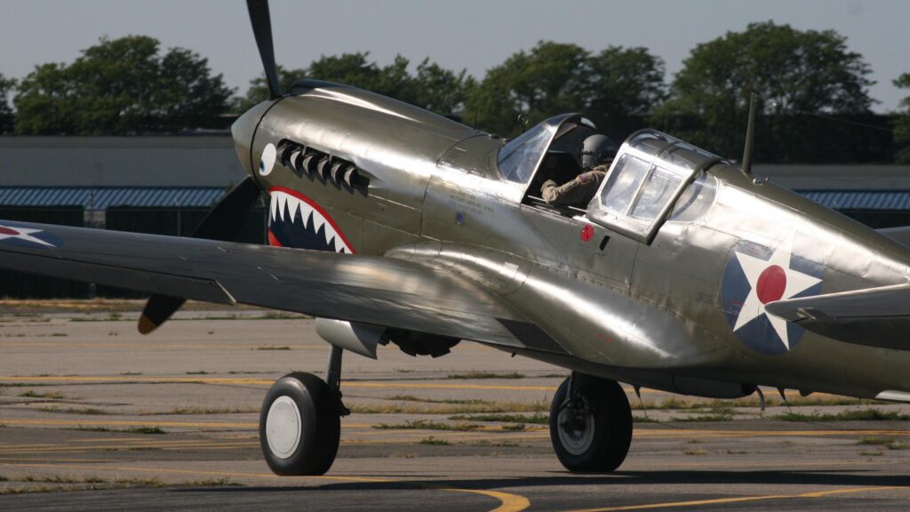 Classic Curtiss P-40 Warhawk Fighter Plane on Tarmac 4K Wallpaper