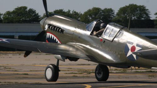 Classic Curtiss P-40 Warhawk Fighter Plane on Tarmac 4K Wallpaper