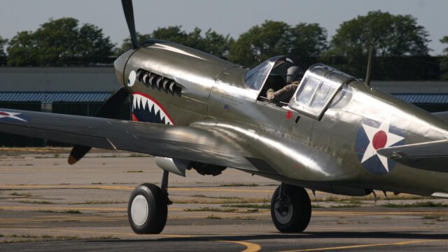 Classic Curtiss P-40 Warhawk Fighter Plane on Tarmac 4K Wallpaper