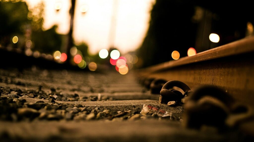 Low Angle View of Industrial Train Tracks at Twilight 4K Desktop Wallpaper