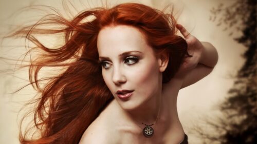 Stunning Portrait of a Woman with Flowing Red Hair 4K Desktop Wallpaper