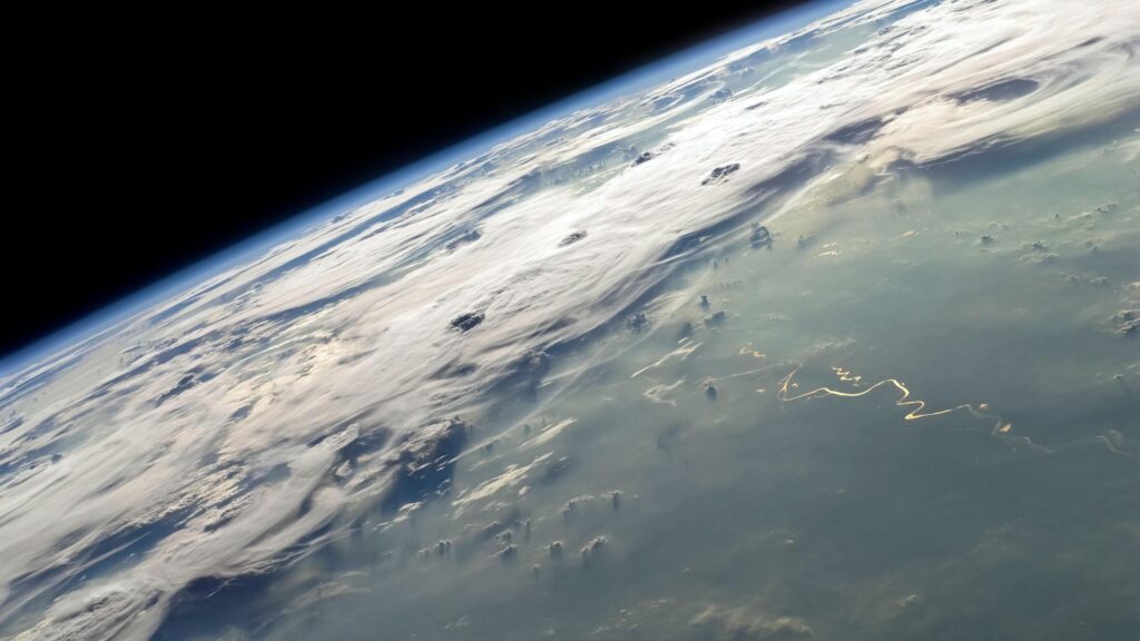 Stunning Earth Horizon View with Glowing Sunlit River from Space 4K Wallpaper