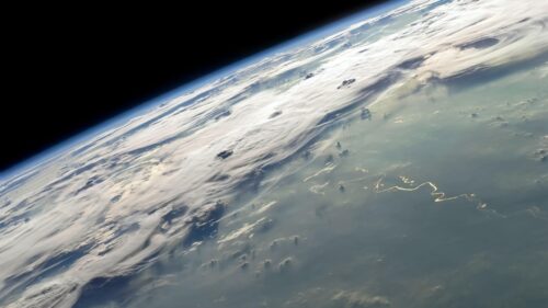 Stunning Earth Horizon View with Glowing Sunlit River from Space 4K Wallpaper
