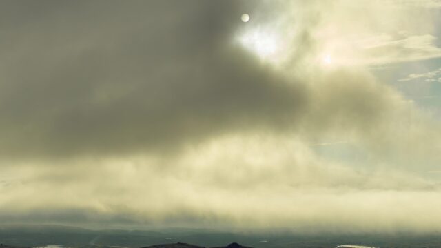 Dramatic Sun Behind Stormy Clouds Over Mountain Landscape PC Wallpaper