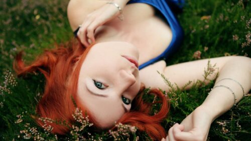 Stunning Redhead Woman Lying in Wild Heathland Nature Desktop Wallpaper