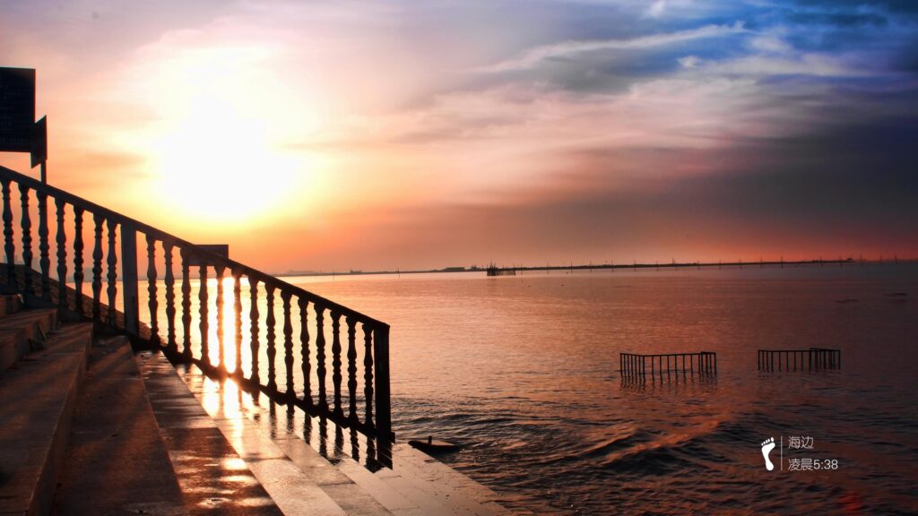Stunning Sunrise over Calm Coastal Waters and Staircase Perspective 4K Wallpaper