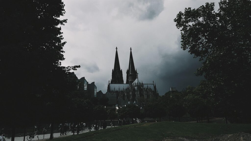 Cologne Cathedral Under Ominous Stormy Skies Desktop Wallpaper