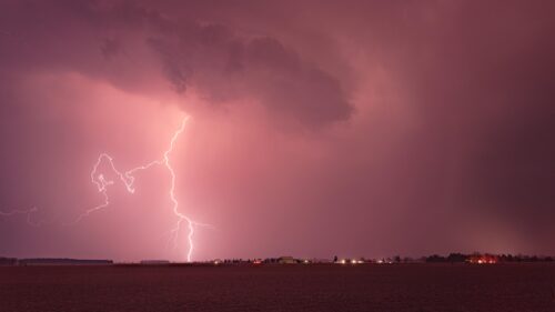 Dramatic Pink Lightning Strike Over Rural Landscape 4K Desktop Wallpaper