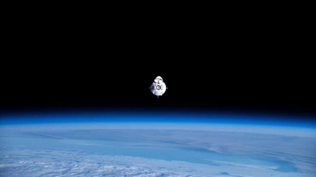 SpaceX Crew Dragon Capsule Floating Above Earth 4K Desktop Wallpaper